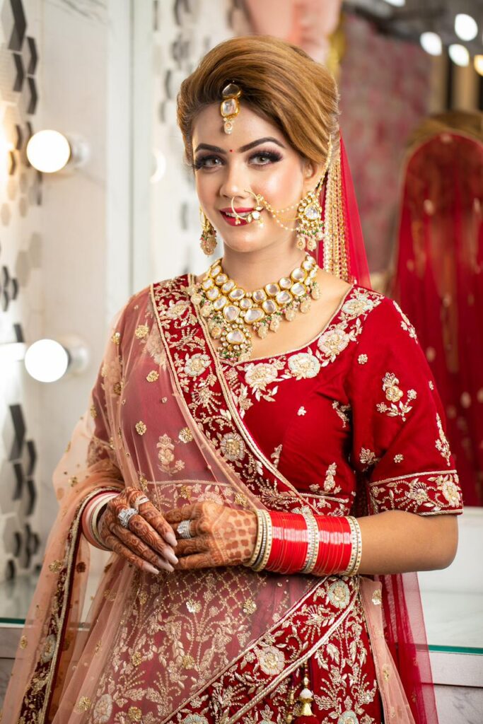 Traditional bridal makeup look with red lehenga by Nithika Aroraa
